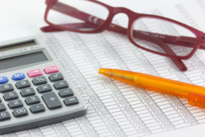 calulator, pen, glasses, spreadsheet - finance concept